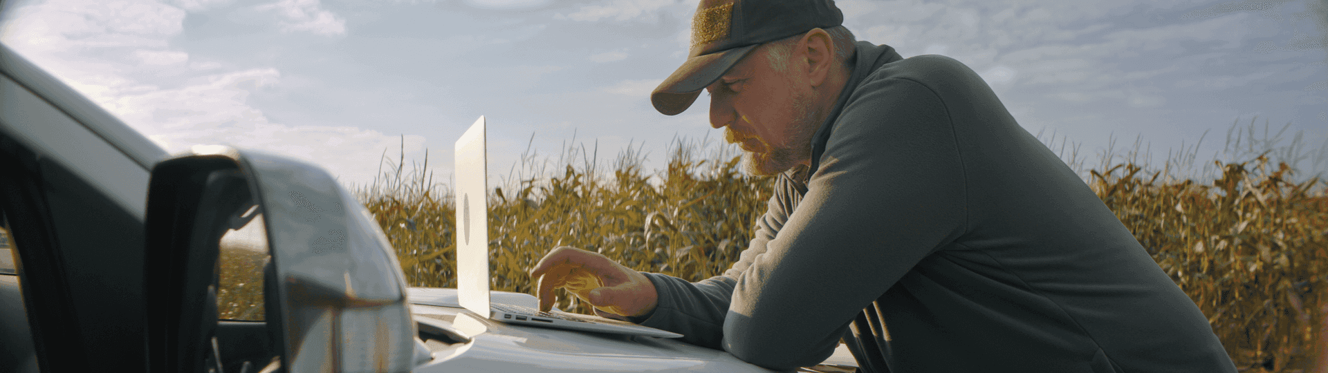 Male farmer calculating finance options using National Ag farm loan calculator