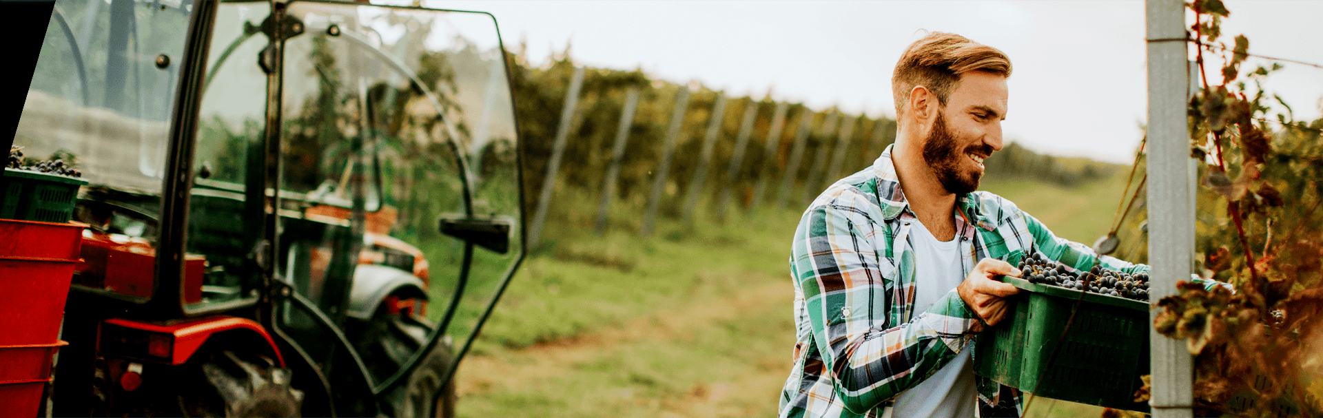 Farmer working in field & happy with the farm loan support from National Ag