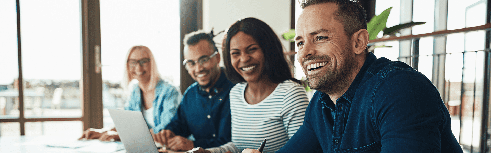 Smiling team members of farm lending sitting together in a meeting